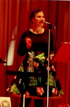 Musicians dressed in Christmas apparel.