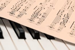 Piano keyboard and music.
