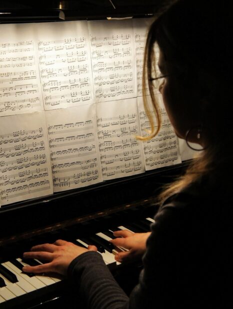young woman playing piano music difficult